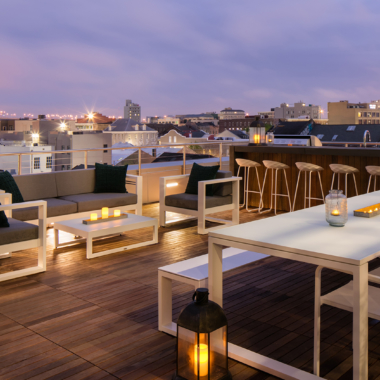 Private rooftop courtyard including tables, chairs and bar at The Beacon at South Market apartments located in Downtown New Orleans.