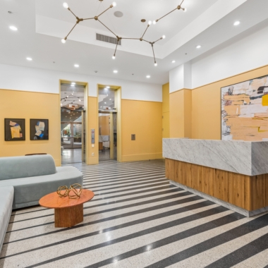 Lobby with reception desk and lounge seating and featured artwork